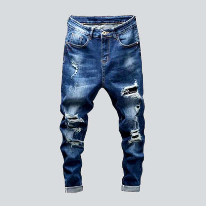 Destroyed blue jeans for men