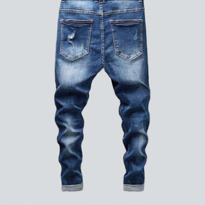Destroyed blue jeans for men
